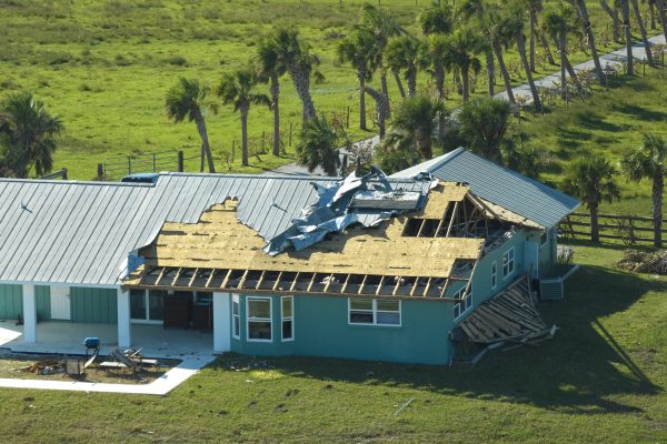 Hurricane Ian destroyed house roof in Florida residential area. Natural disaster and its consequences.